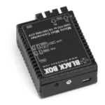 Black Box LMC4004A media converter back view showing power input, configuration DIP switches, and chassis mounting interface